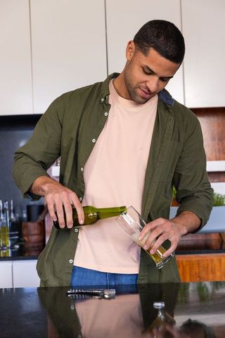 Man enjoying casual beer at modern kitchen island