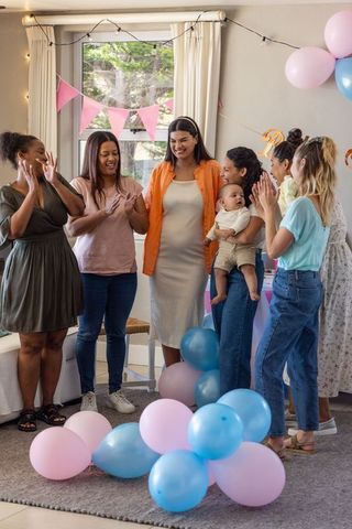 Diverse Women Celebrating Baby Shower with Balloons