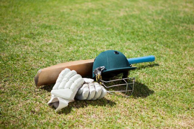 High angle view of cricket equipment on field during sunny day