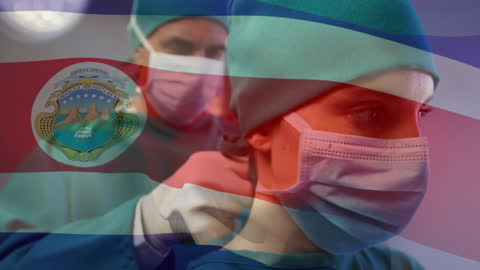 Healthcare professionals wearing masks with an overlaid video of the Spain flag signifies the global effort against the COVID-19 pandemic. The scene emphasizes the dedication and teamwork of medical staff, showcasing commitment to public health during challenging times. Ideal for use in articles about pandemic response, healthcare sectors in Spain, or global medical contributions.
