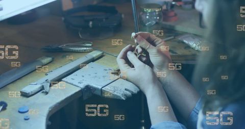 Jeweler Examining Ring with 5G Technology Concept Overlay