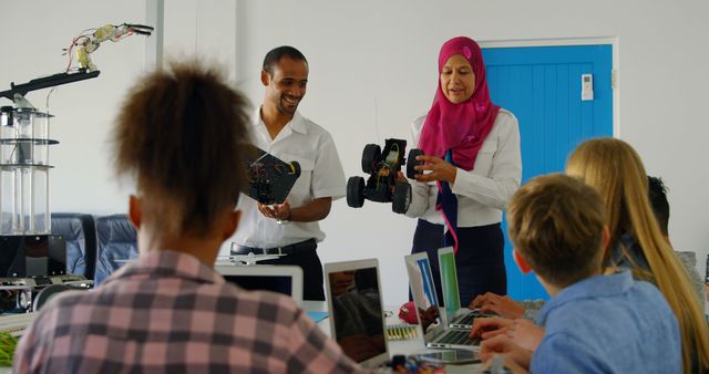 Diverse students collaborating in robotics class with futuristic gadgets - Download Free Stock Images Pikwizard.com