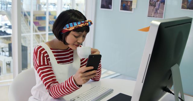 Young Woman Drinking Coffee and Using Smartphone at Work - Download Free Stock Images Pikwizard.com