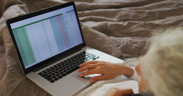 Senior person working on laptop with spreadsheet - Download Free Stock Images Pikwizard.com