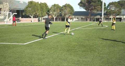 Teen Soccer Players Competing Intensely on School Field