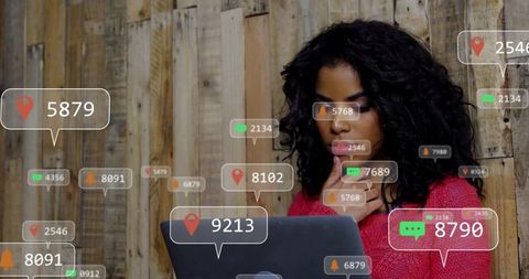 Young woman typing on laptop with floating social notifications and data overlays