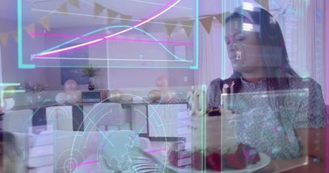 Family celebrating baby birthday at pastel dining table with augmented reality data overlay