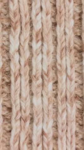 Shifting camera revealing knitted rib swatch changing focus close-up with wool halo