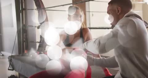 Trainer Wrapping Boxer in Ring Demonstrating Skill and Dedication