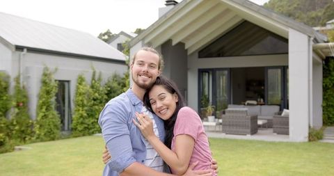 Happy Young Biracial Couple Embracing in Backyard