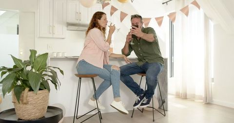 Couple Enjoying Selfie Moment Together in Bright Modern Kitchen