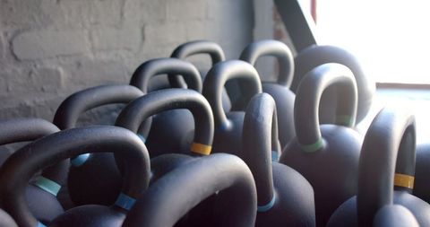 Array of Kettlebells in Sunlit Gym Ready for Workout