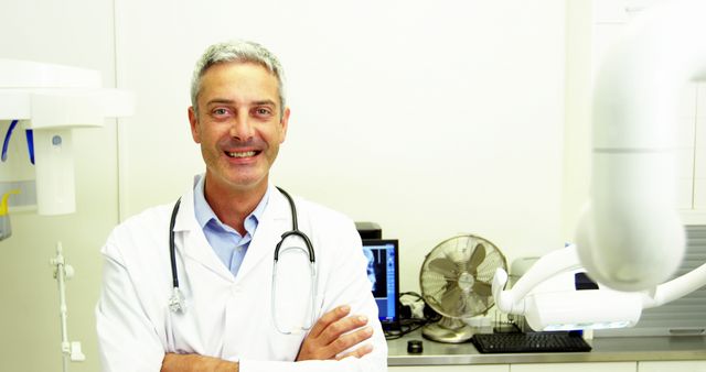 Smiling Male Doctor in Medical Office with Equipment - Download Free Stock Images Pikwizard.com