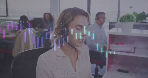 Businesswoman with headset analyzing data in modern office