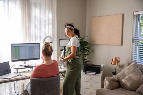 Diverse women collaborating in home office with modern technology