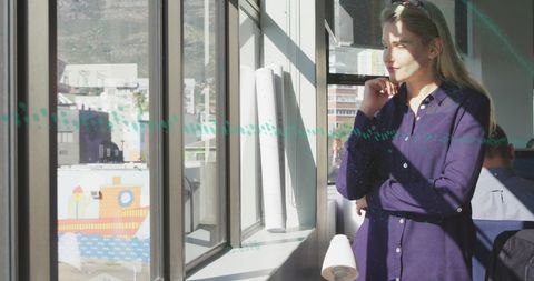 Businesswoman Analyzing Financial Data by Office Window