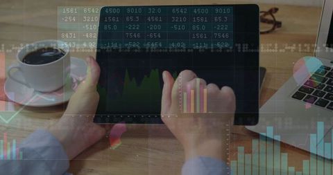 Financial Analyst Reviewing Data on Tablet at Office Desk