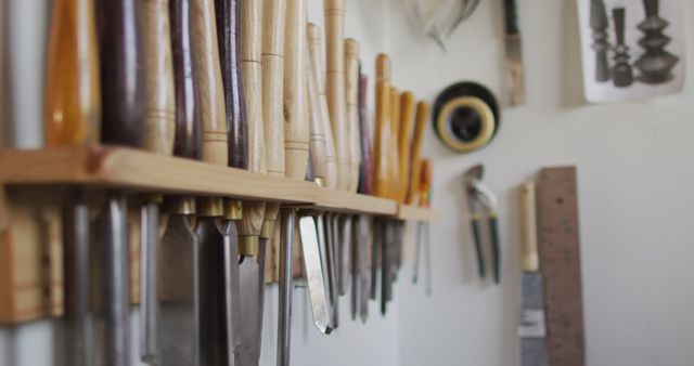 Multiple woodworking tools hanged on a stand in a carpentry shop. carpentry, craftsmanship and handwork concept