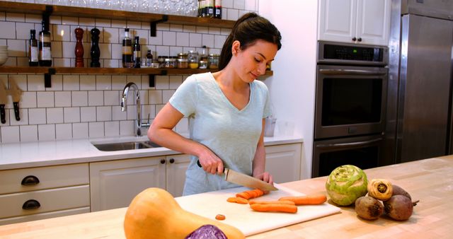 Woman Preparing Carrot in Modern Kitchen with Fresh Vegetables on Counter - Download Free Stock Images Pikwizard.com