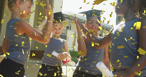 children are joyfully celebrating their graduation outside, with golden confetti falling around them. they are smiling and embracing the moment of achievement with blonde and undercut hairstyles. this scene captures the essence of happiness, success, and new beginnings during an elementary milestone. use this for educational materials, graduation ceremony promotions, and event invitations.