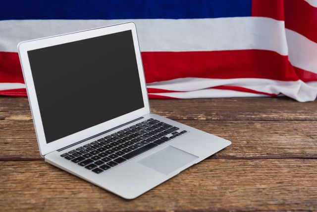 Laptop on Wooden Table with American Flag Background - Download Free Stock Photos Pikwizard.com
