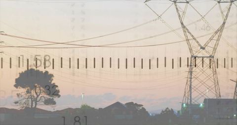 Steel lattice pylon framing suburban dusk with power lines pastel sky silhouette