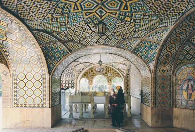 Intricate mosaic tiles covering historical monument reflecting rich Islamic culture, providing useful content for travel blogs, history books, cultural articles, and educational materials focusing on traditional Islamic architecture and heritage.