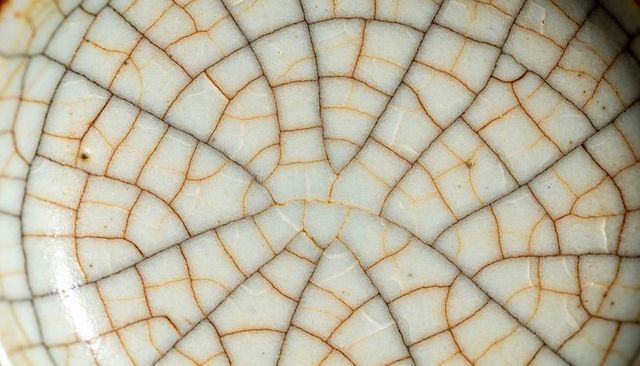 Radiating crackle glaze on ceramic bowl interior close-up texture and organic pattern macro