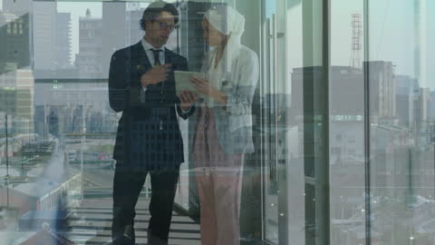 Business Colleagues Discussing Projects with Cityscape View