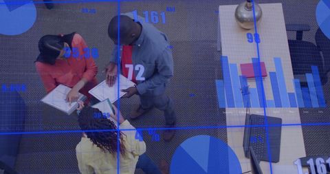 Colleagues Collaborating in High-Tech Office with Data Interface