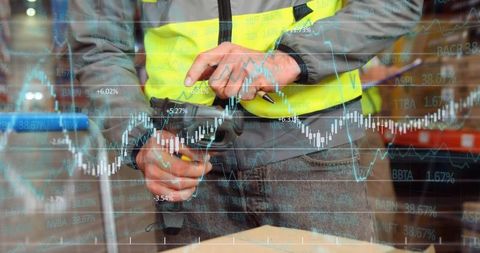 Warehouse worker with barcode scanner analyzing inventory data