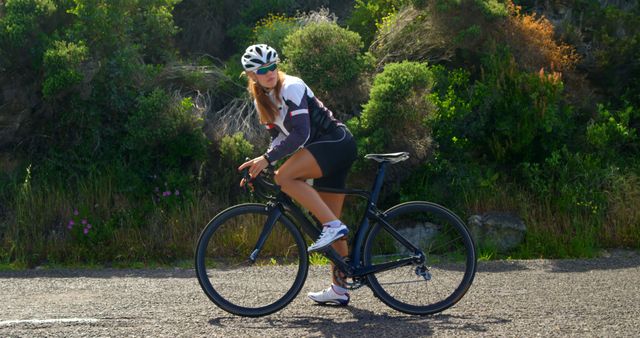 Female Cyclist Enjoying Sunny Ride on Country Road - Download Free Stock Images Pikwizard.com