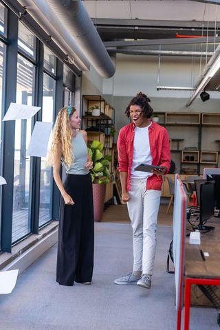 Diverse colleagues celebrating success in modern open-plan office