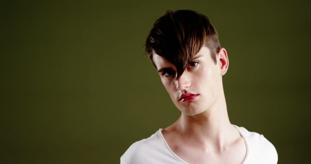 Young Man with Modern Hairstyle on Green Background - Download Free Stock Images Pikwizard.com