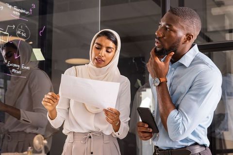 Diverse Team Collaborating with Glass Board and Technology