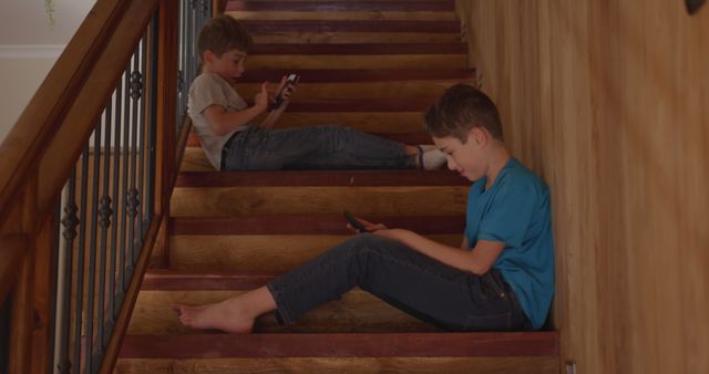 Two Boys Sitting on Stairs Using Smartphones - Download Free Stock Images Pikwizard.com