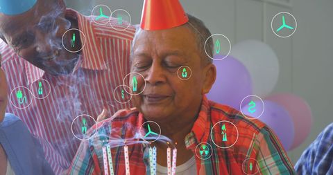 Senior Man at Festive Birthday Celebration with Digital Icons Overlay