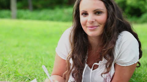 Brunette Woman Writing in Natural Park Setting