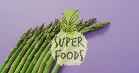 Fresh Asparagus Bunch with Super Foods Text on Violet Background