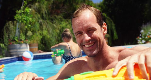 Portrait of man smiling near swimming pool on a sunny day