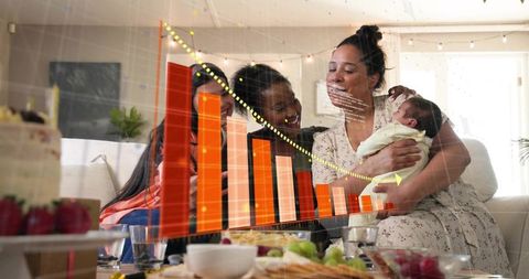 Family gathering celebrating new baby while reviewing growth chart overlay