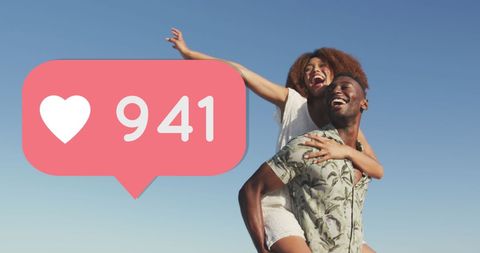 Joyful Couple Enjoying Beach With Social Media Love Icon Overlay
