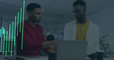 Colleagues Analyzing Financial Data on Laptop in Office