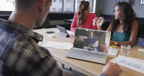 Team Collaborating Over Video Call in Modern Office Space