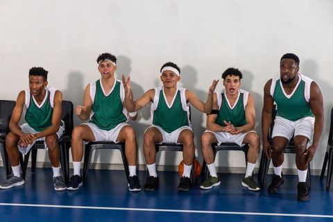 Diverse Male Basketball Teammates Engaging on Sidelines