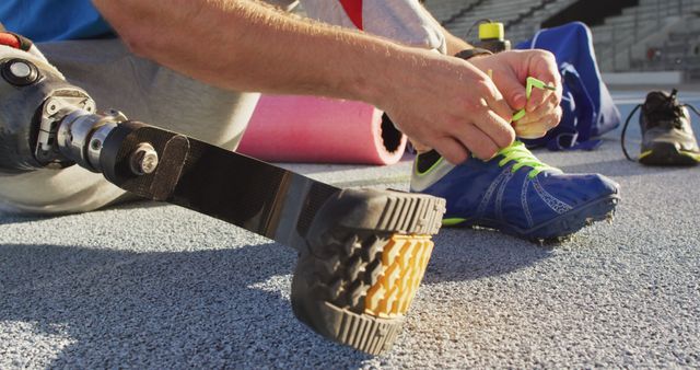 Athlete with Prosthetic Leg Tying Running Shoe at Track - Download Free Stock Images Pikwizard.com