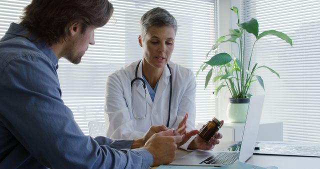 Doctor Consulting Male Patient in Bright Medical Office - Download Free Stock Images Pikwizard.com