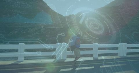Hiker journeying along mountain highway under a clear sky