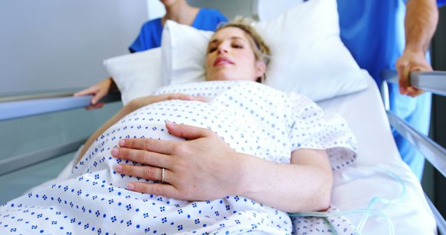 Pregnant Woman in Hospital Bed During Labor with Medical Staff Assisting - Download Free Stock Images Pikwizard.com