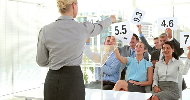 Group of Business Professionals Evaluating Presentation with Scorecards - Download Free Stock Images Pikwizard.com